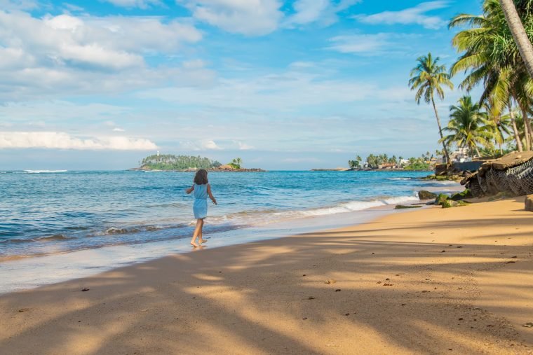 Child girl on the beach in Sri Lanka. Selective focus.